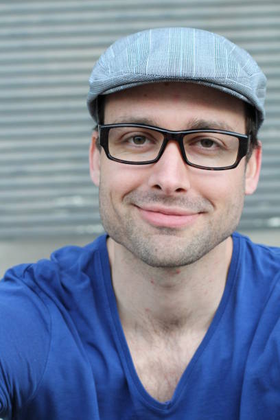 istock Trendy good looking young man smiling 825900842