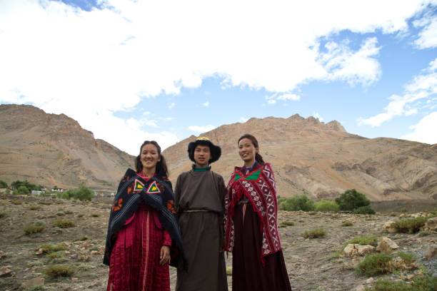 istock Buddhist man and women posing in front of mountains 825902796