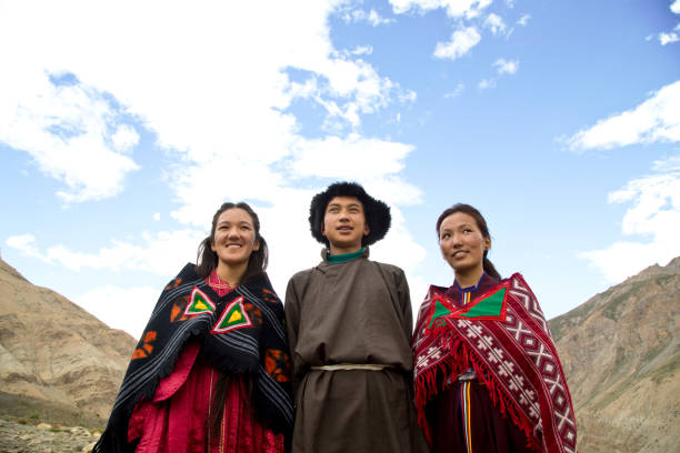 istock Buddhist man and women posing in front of mountains 825903054