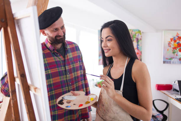 istock Couple fine artists drawing in studio 825903074