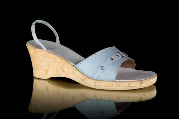 istock Female Blue and White Sandal on Black Background. 825906416