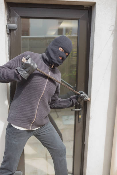 istock Burglar breaking into home using crow bar 825911668