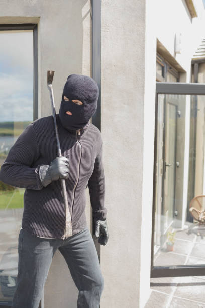 istock Burglar hiding behind wall 825911718