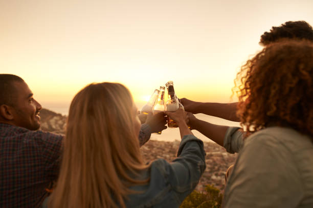 Cropped shot of a group of young people drinking during an early morning hike