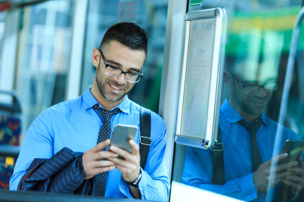 istock Businessman traveling with a bus and using smart phone 825918912