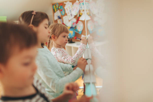 istock Preschoolers drawing on the blackboard 825921922