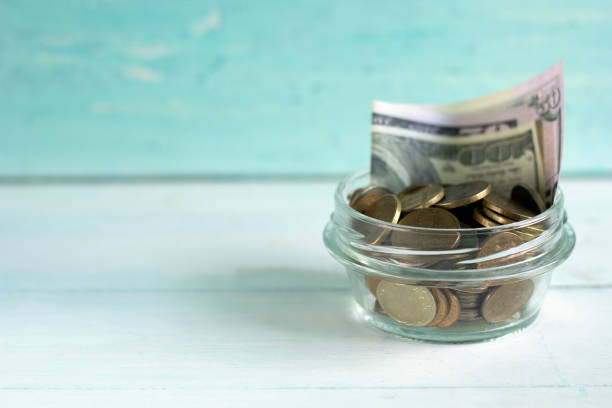 istock banknotes and coins in a jar 825922666