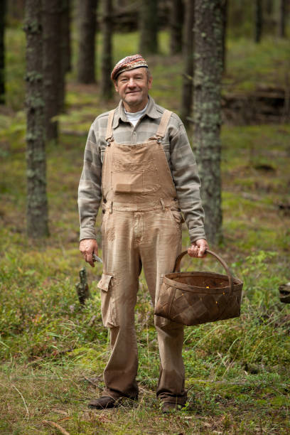 istock Man gathers mushrooms in the forest 825922998