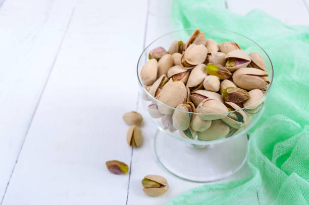 istock Pistachio nuts in a bowl  on white background. 825925730