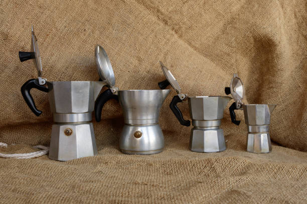 Four italian moka on coffee jute bag Tavigliano, Italy - August, 01, 2017: Four italian moka in vintage still life style, coffee jute bag in background. moka stock pictures, royalty-free photos & images