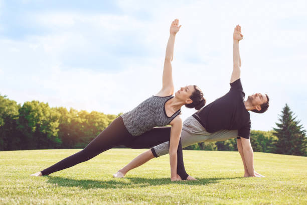 istock People practice acro yoga outdoors healthy lifestyle 825927472