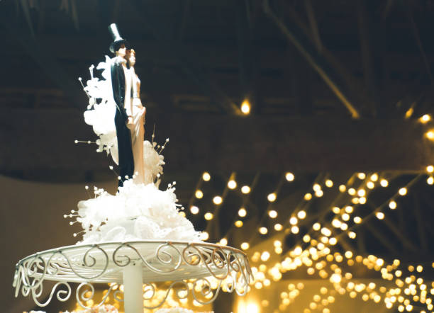 istock Bride and Groom on Wedding Cake 825927554