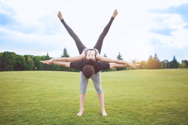 istock People practice acro yoga outdoors healthy lifestyle 825927622