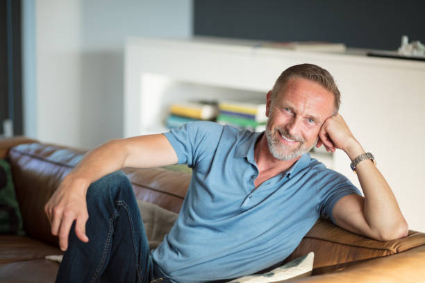 istock mature man relaxing on the sofa 825927642