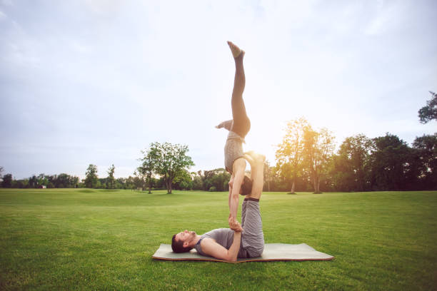 istock People practice acro yoga outdoors healthy lifestyle 825934154