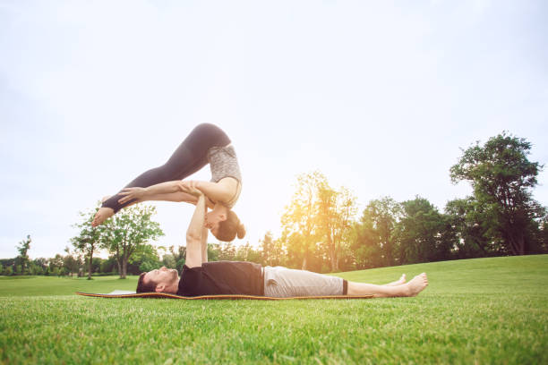 istock People practice acro yoga outdoors healthy lifestyle 825934184