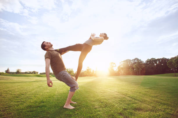 istock People practice acro yoga outdoors healthy lifestyle 825934284