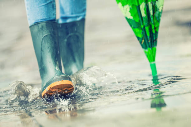 istock Girl in rubber boots outdoors in rainy day 825934442