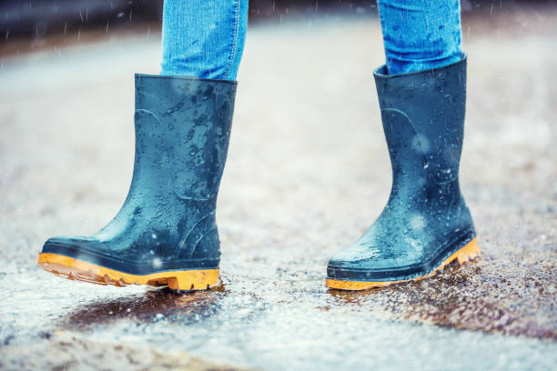 istock Girl in rubber boots outdoors in rainy day 825934454