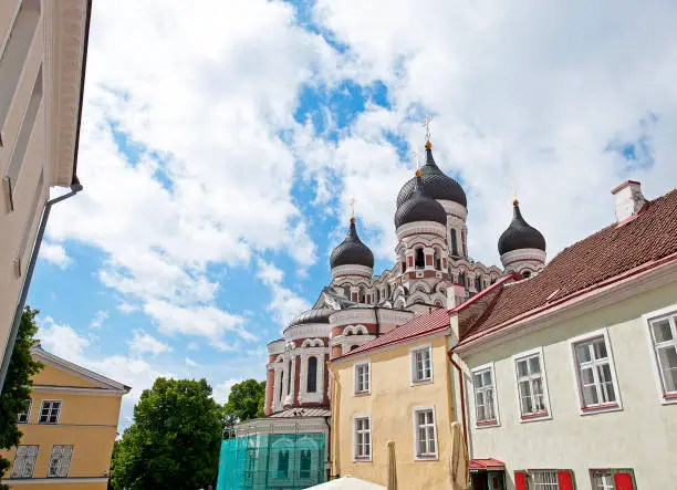 View across the tradtional colourful housing architecture of Tallinn to the triple domes of Alexander Nevski Cathedral, a large and richly decorated Russian Orthodox church, completed on Toompea Hill in 1900 to a design by Mikhail Preobrazhensky, when Estonia was part of the Czarist Empire, Talinn, Estonia