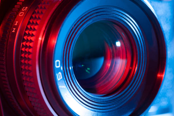 istock Closeup of retro camera lens with red and blue lighting 825937674