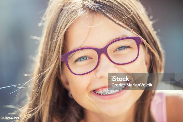 Happy Smiling Girl With Dental Braces And Glasses Young Cute Caucasian Blond Girl Wearing Teeth Braces And Glasses Stock Photo - Download Image Now