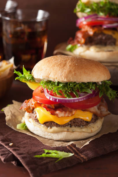 istock bacon cheese burger with beef patty tomato onion 825937802