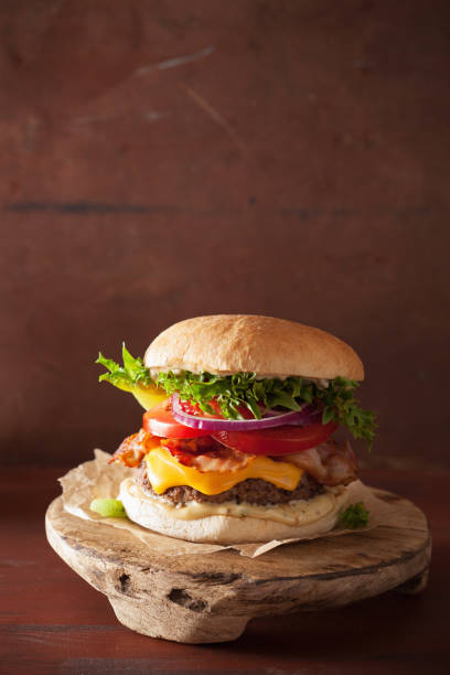 istock bacon cheese burger with beef patty, tomato and onion 825937914
