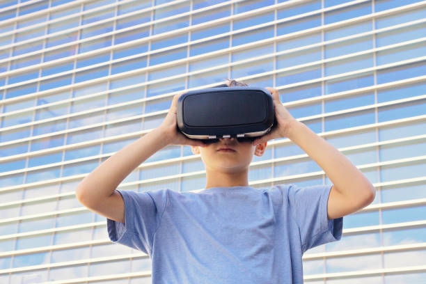 istock Child with virtual reality goggles in the city 825938024