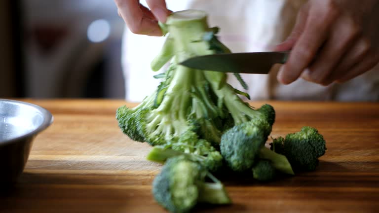 Chef preparing broccoli for cooking