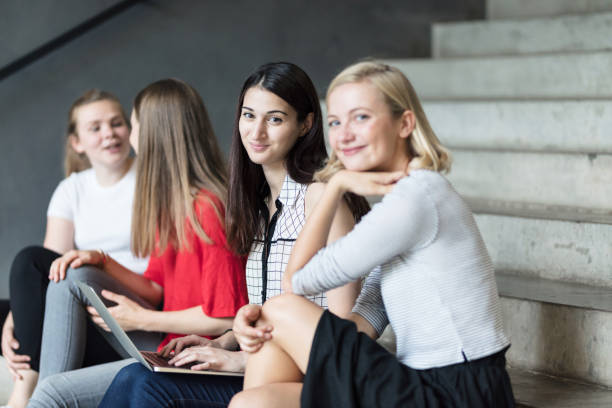 istock Young women working with technologies while they are sitting on the stairs 825945664