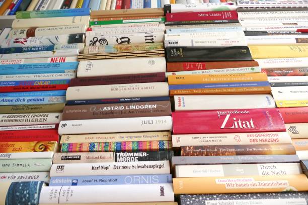 istock Filled books shelf close up with a stack of books leaning at it 825948804