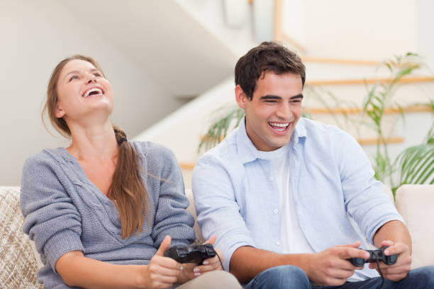 istock Happy couple playing video games 825954108