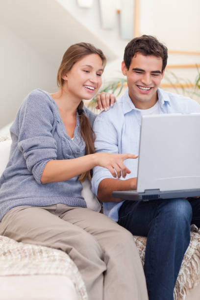 istock Portrait of a couple using a laptop 825954396
