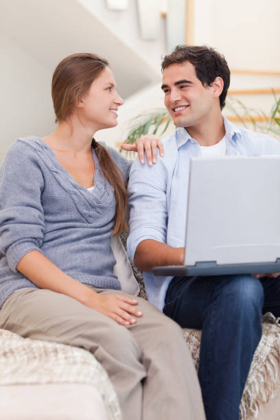 istock Portrait of a smiling couple using a laptop 825954464