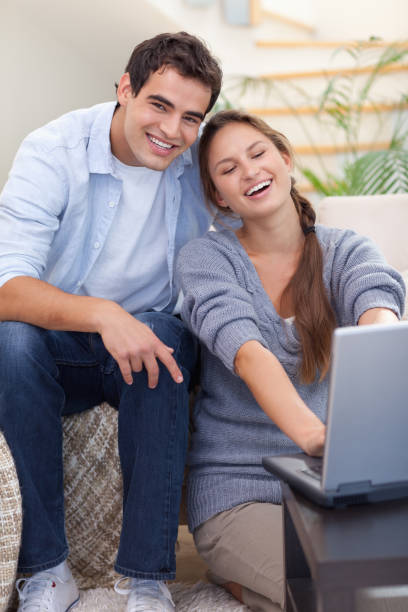 istock Portrait of a smiling couple using a notebook 825954818