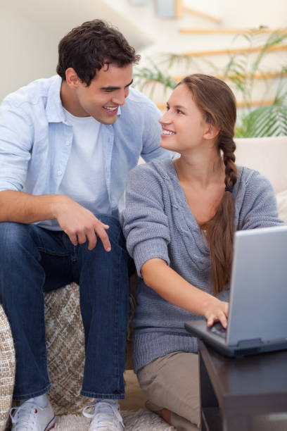 istock Portrait of an in love couple using a notebook 825954940