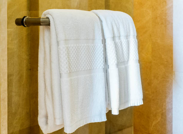 istock white towel on a hanger prepared to use in bathroom 825955124