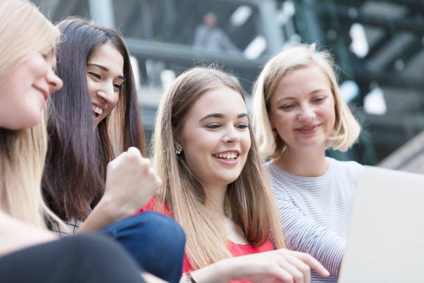 istock Young women working with technologies while they are sitting on the stairs 825955202