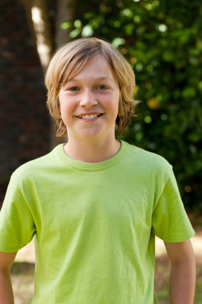 istock Little boy looking at the camera in the garden 825957744
