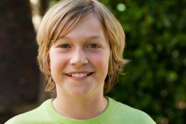istock Little boy looking at the camera in the garden 825957812