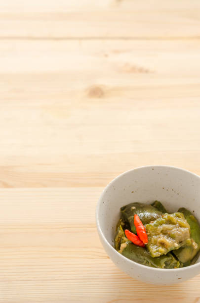 istock Fried eggplant with chili on wooden table background 825958214