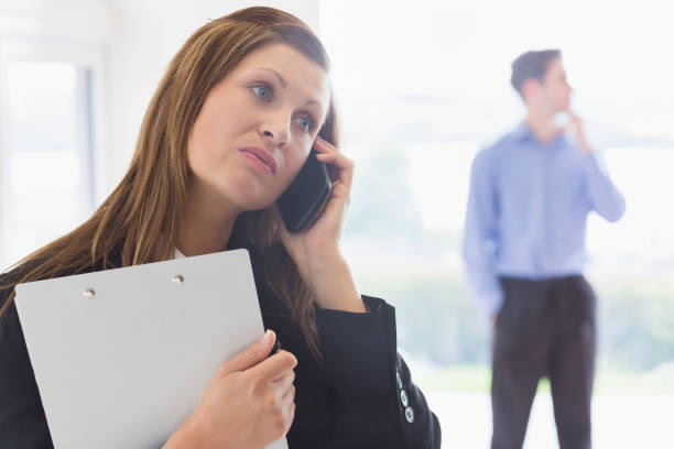 istock Estate agent looking disappointed on the phone 825964890