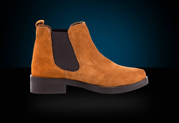 istock Female Brown Boot on Blue Background, Isolated Product. 825965962