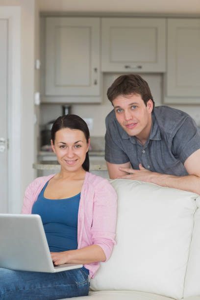 istock Woman working on the laptop on the couch 825968732