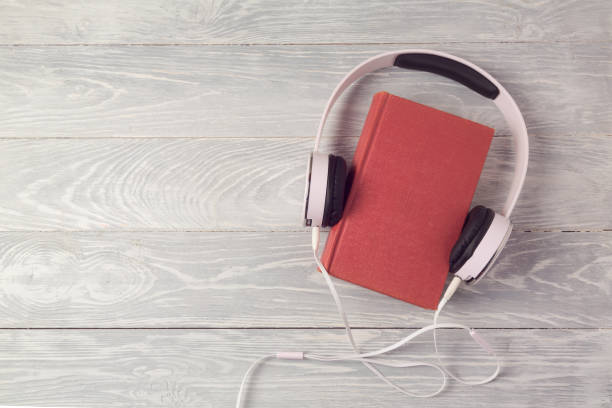istock Audio book concept with old book and headphones. View from above. Flat lay 825968770