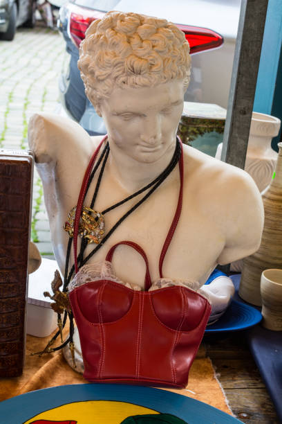 Greek god bust with red leather bodice on a flea market
