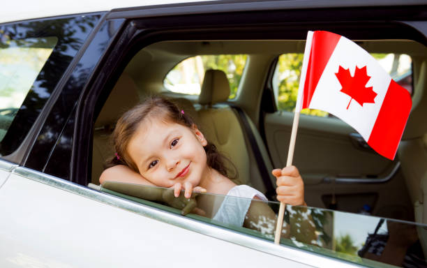 istock Girl Holding Canadian Flag 825972676