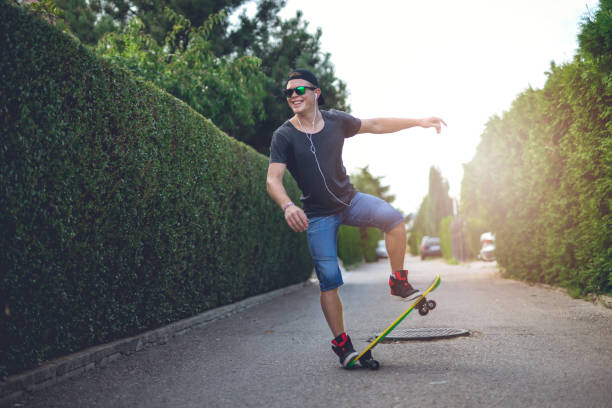 istock Man skateboarding on city street 825977500