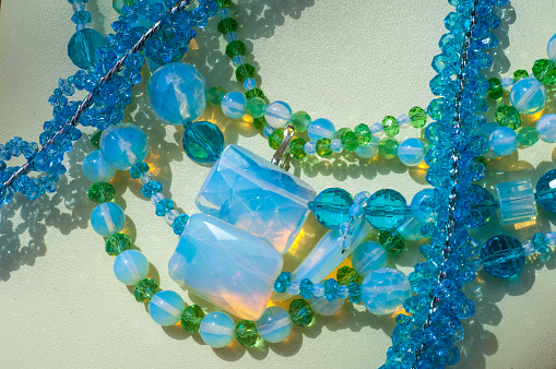 Close-up of a group of various colorful gemstones on white background.